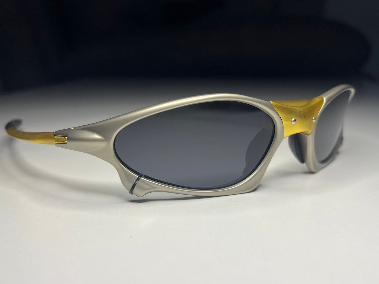 Sunglasses with gold and silver frame on a white background