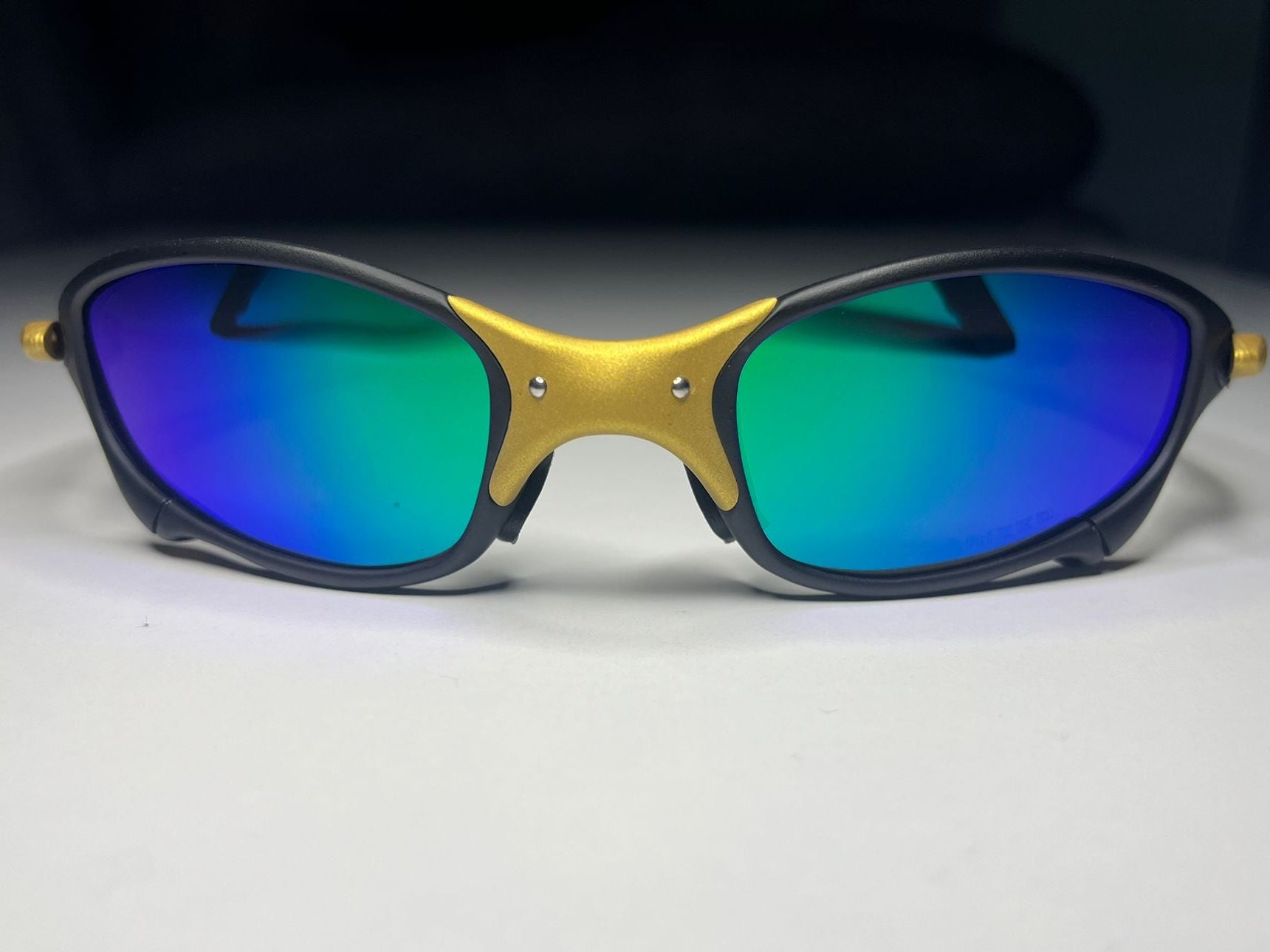 Sunglasses with blue reflective lenses on a light gray background