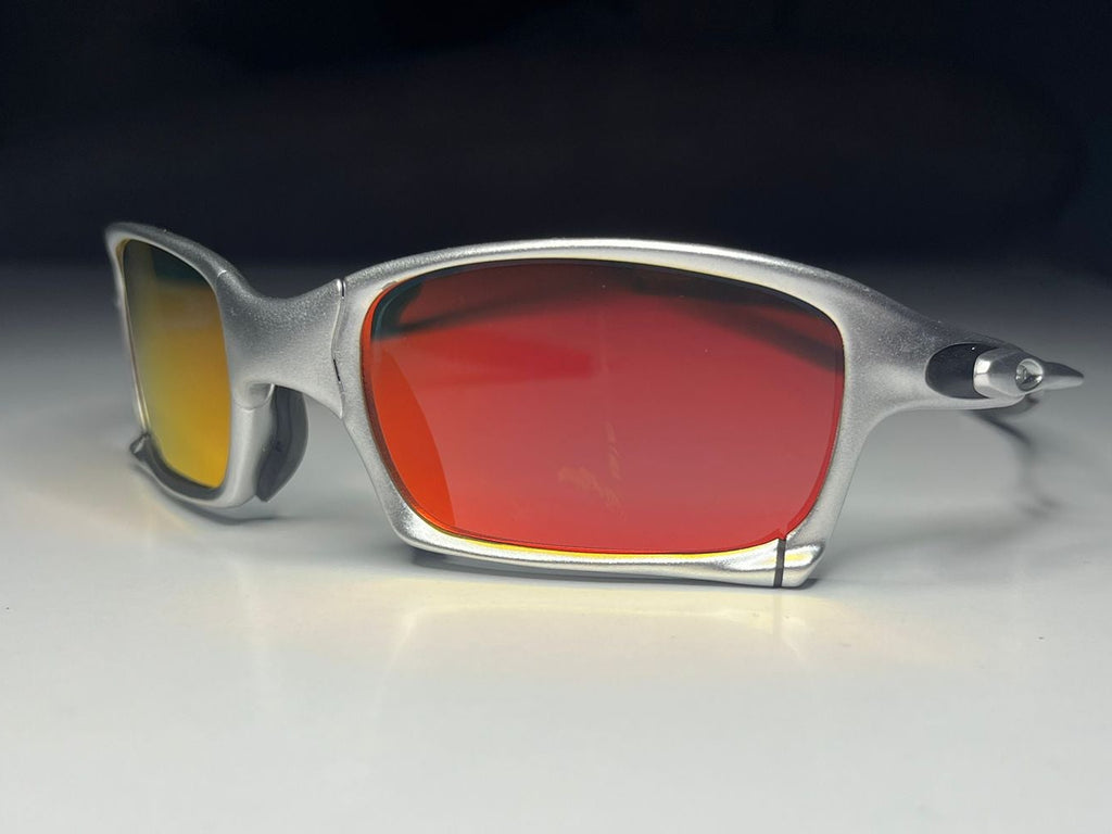 Sunglasses with red and yellow lenses on a white surface