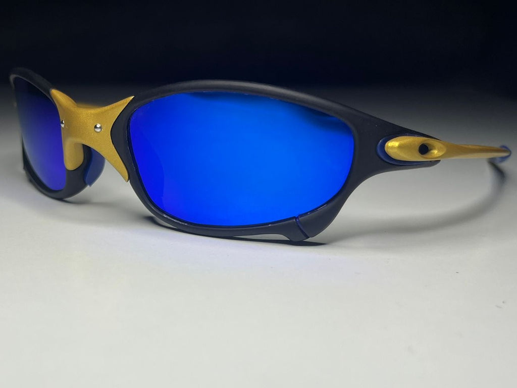 Sunglasses with blue lenses and gold accents on a white background