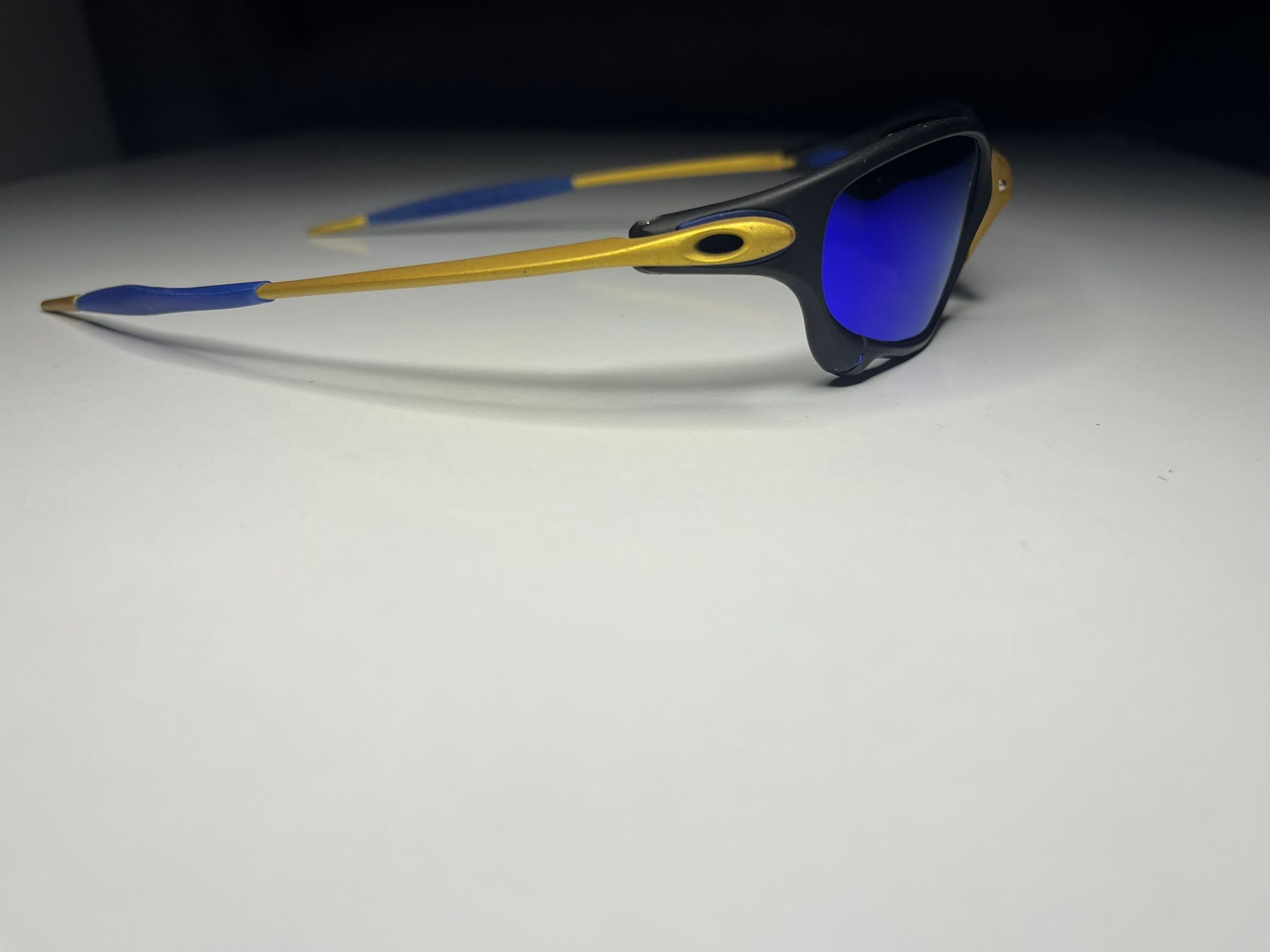 Resolute- 24K Gold and Black Frames- Metallic Blue Lenses Polarized