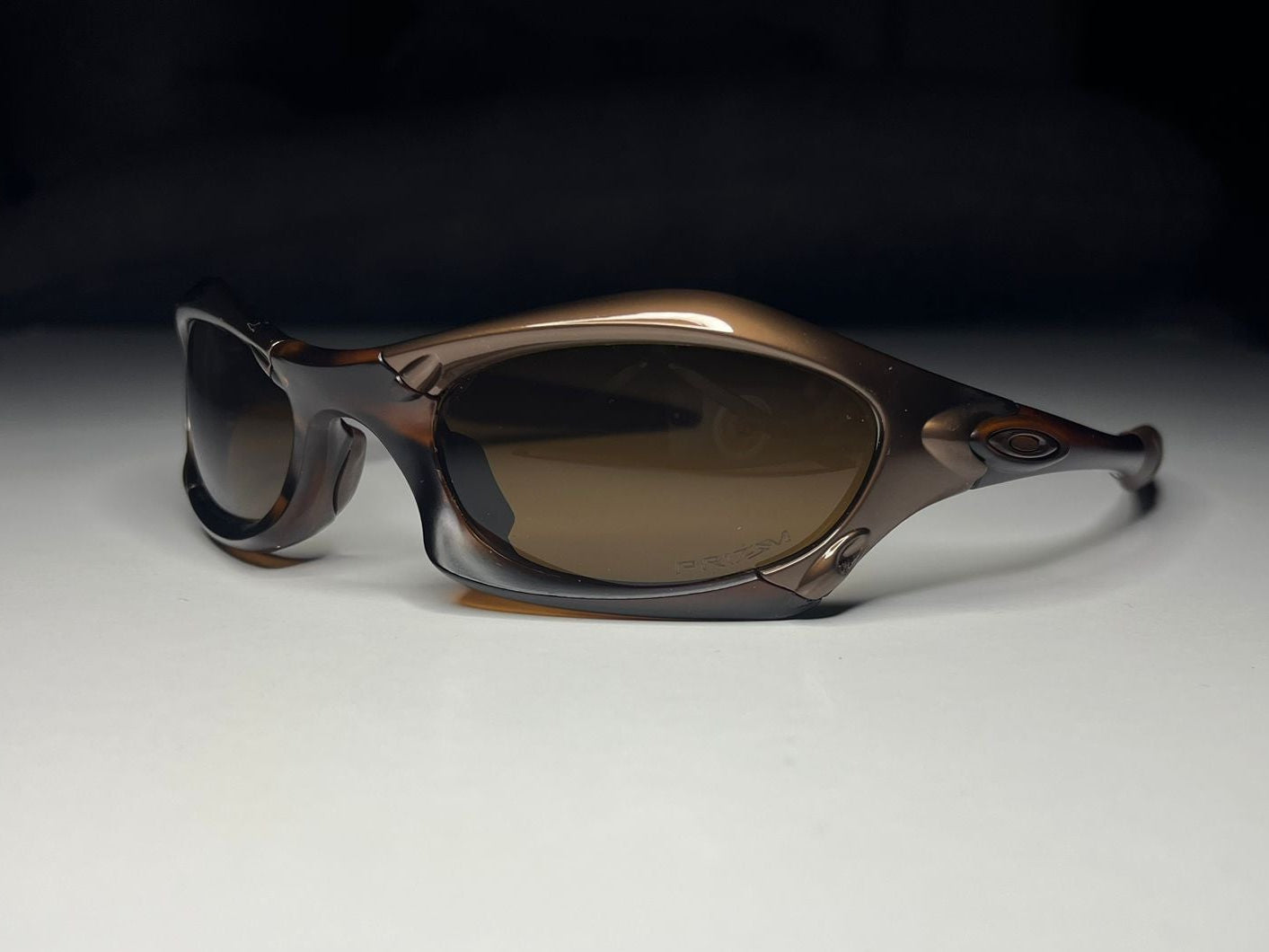 Sunglasses with brown gradient lenses on a white surface
