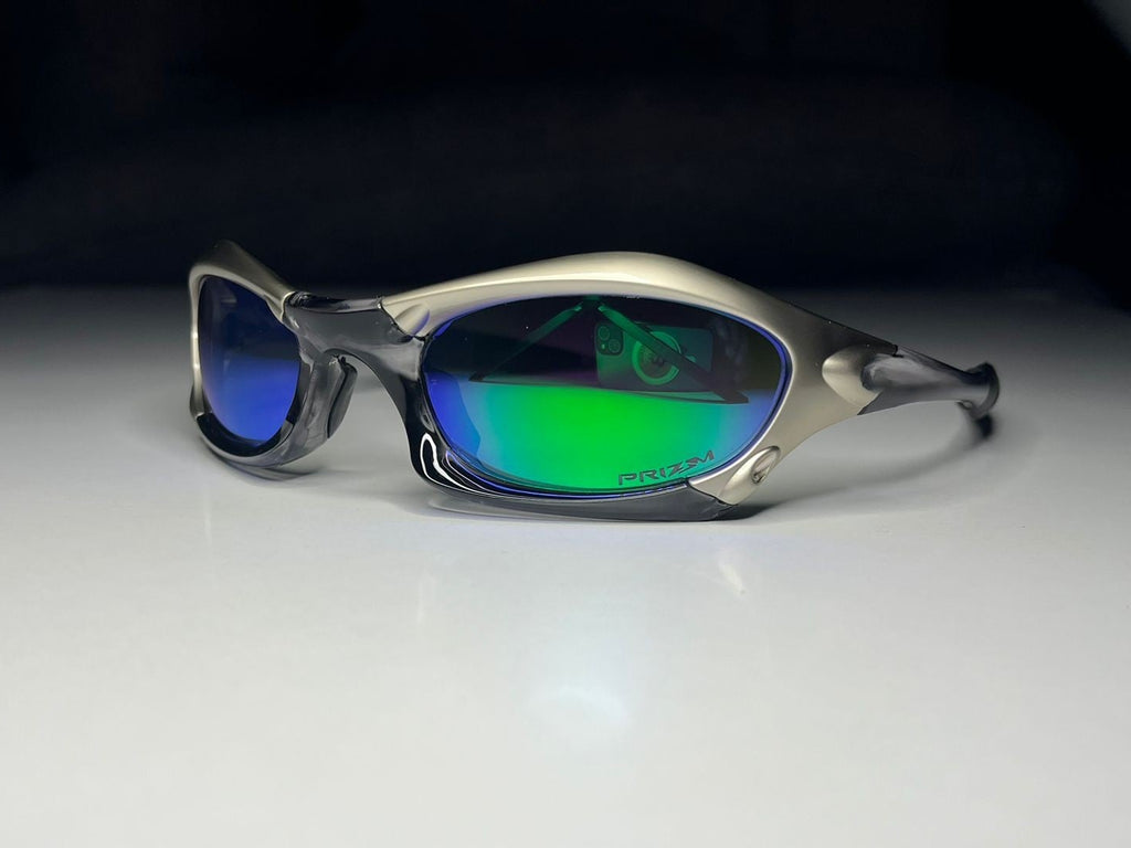 Sunglasses with reflective green lenses on a white surface