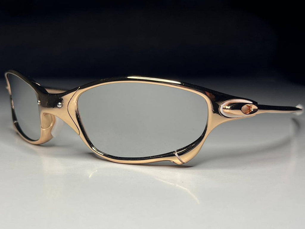 Gold-framed eyeglasses on a white surface with a black background