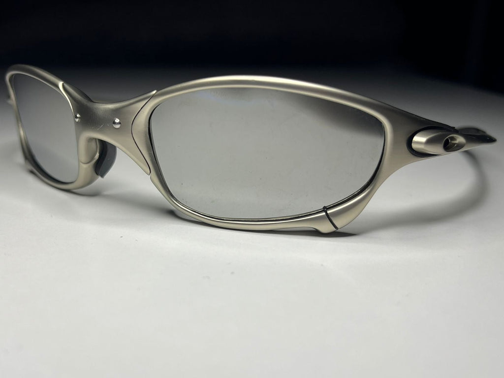 Sunglasses with a metallic frame on a light gray background