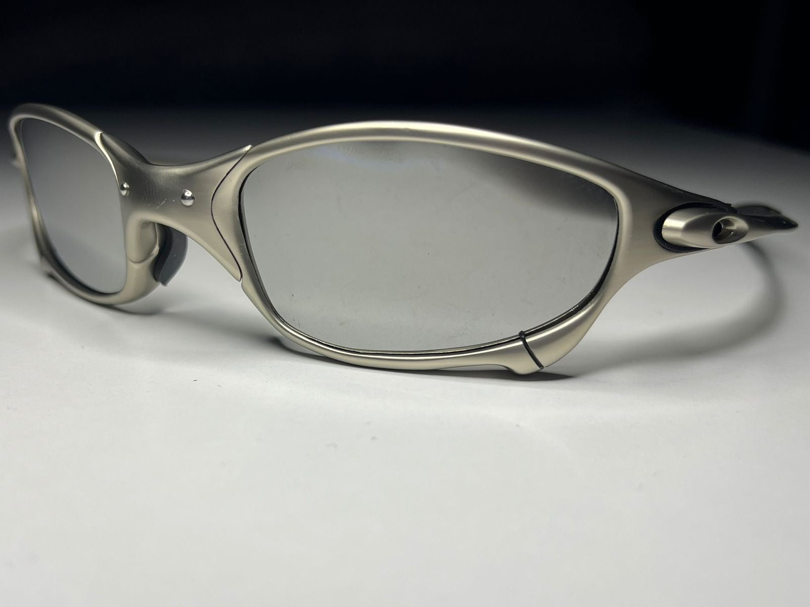 Sunglasses with a metallic frame on a light gray background