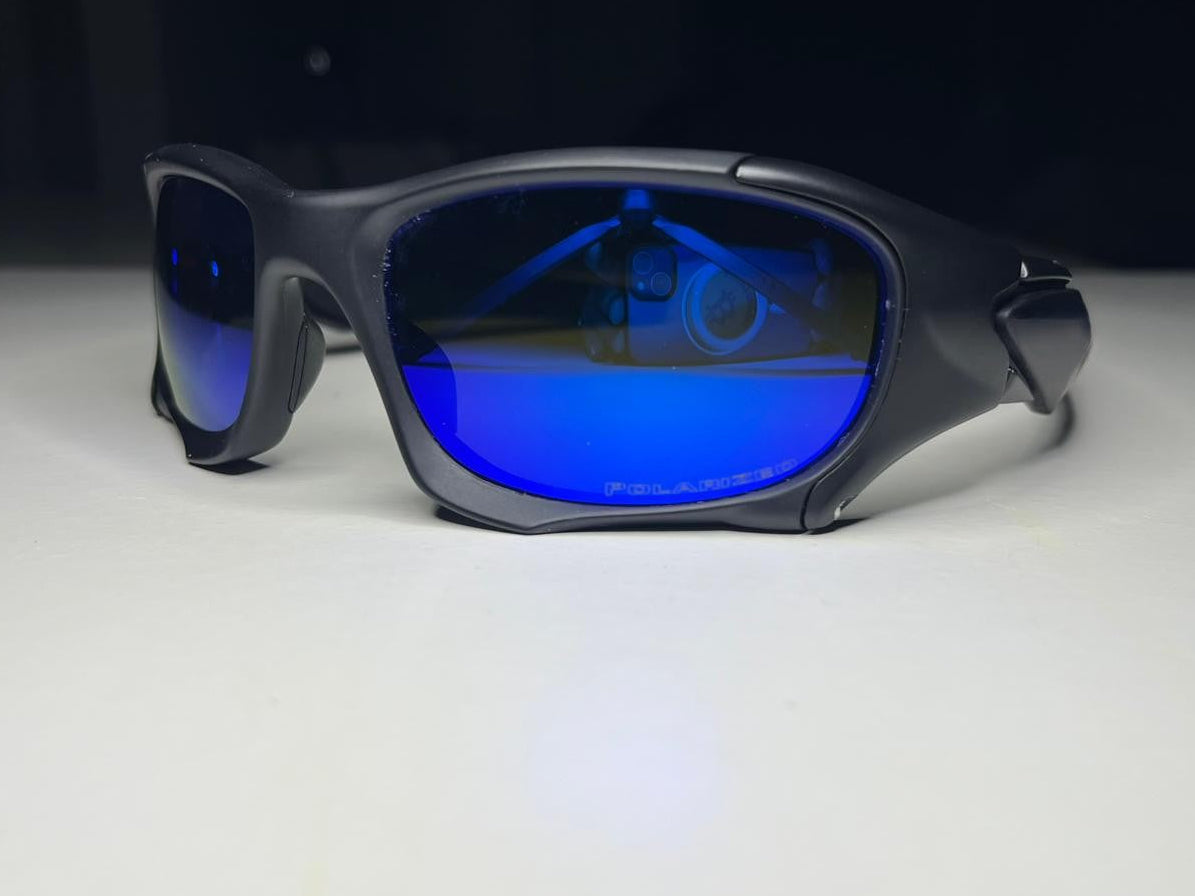 Sunglasses with blue lenses on a white surface