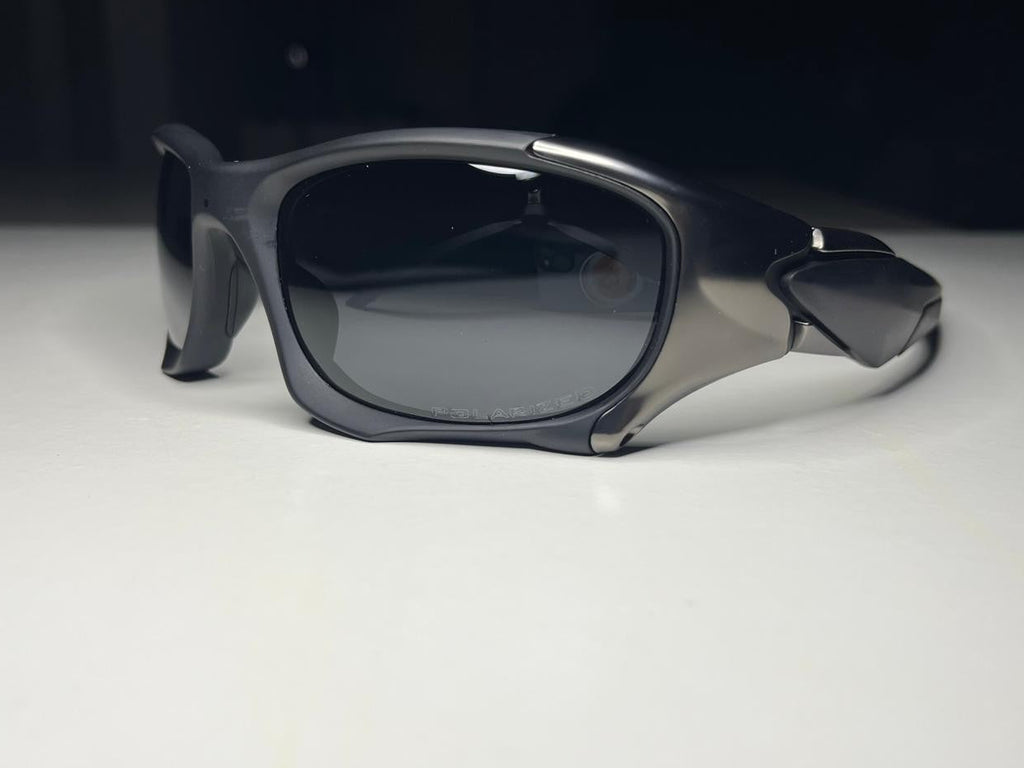 Sunglasses with dark lenses on a white surface