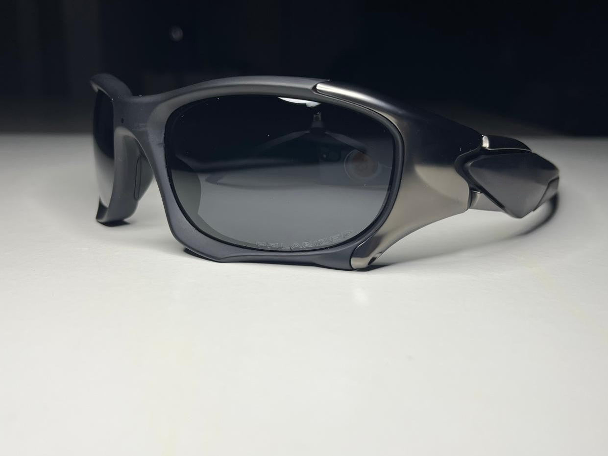 Sunglasses with dark lenses on a white surface