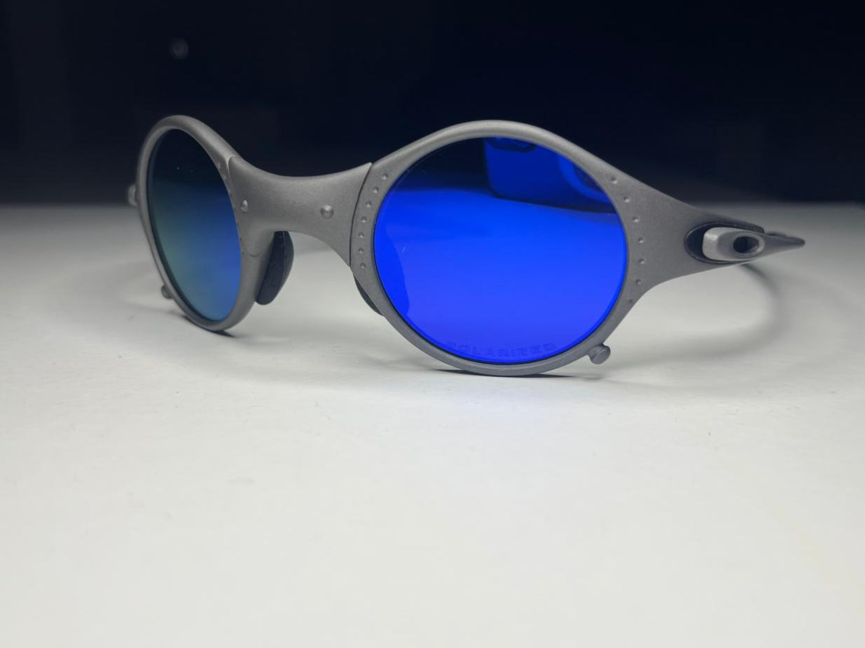 Sunglasses with blue lenses and gray frame on a white surface