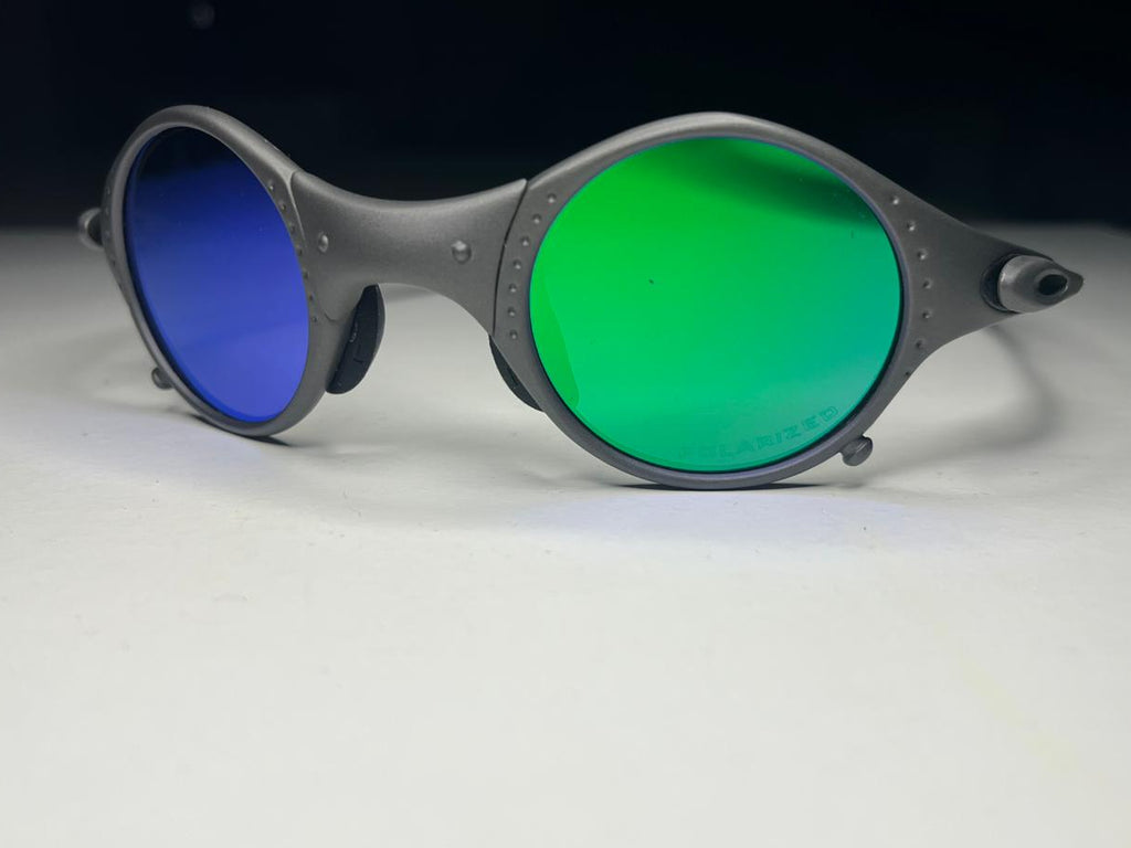 Sunglasses with green lenses and gray frame on a white background