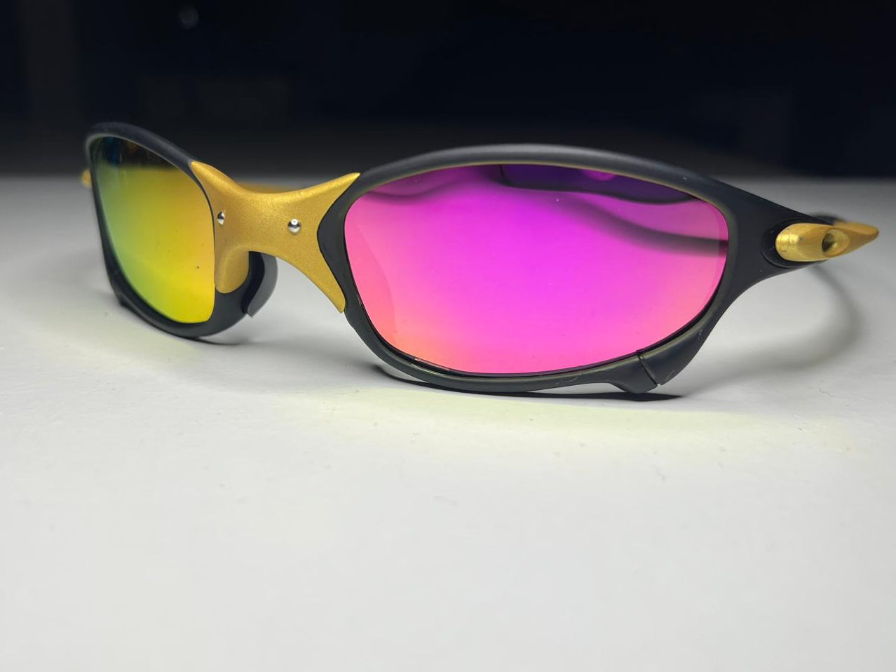 Sunglasses with pink and yellow lenses on a white background