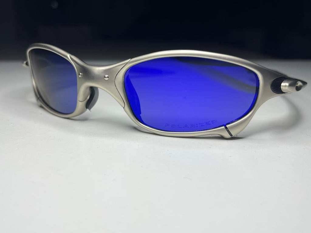 Sunglasses with blue lenses and silver frame on a white background